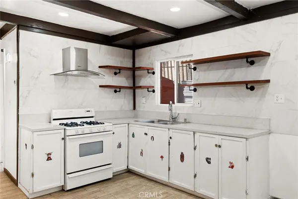 a kitchen with stainless steel appliances white cabinets and white appliances