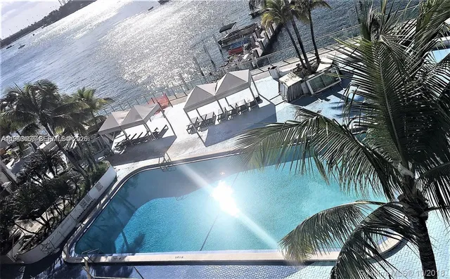 a view of a tall building next to a yard