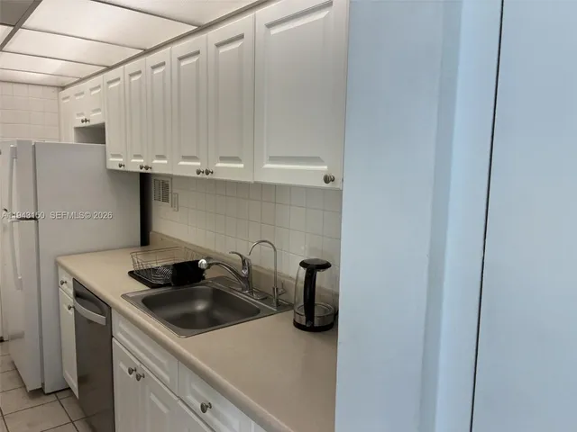 a kitchen with a sink and cabinets