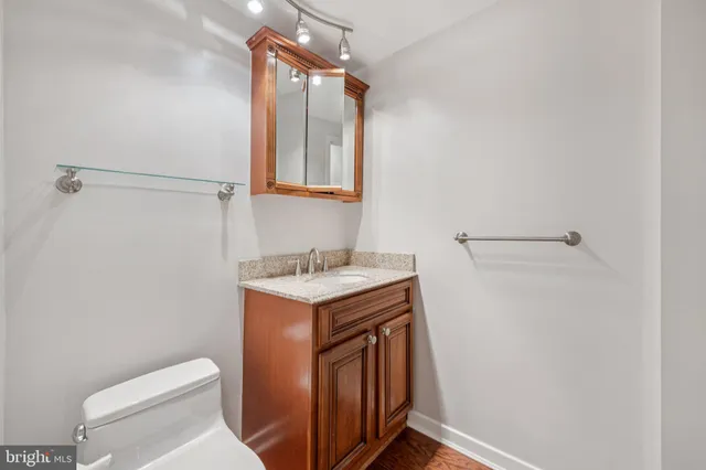 a bathroom with a sink a toilet and mirror