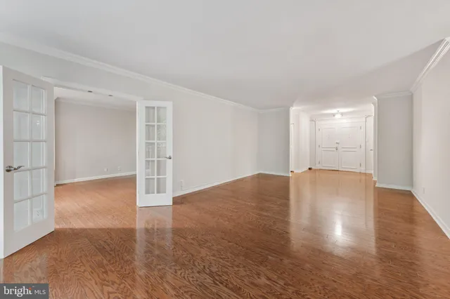 a view of empty room with wooden floor