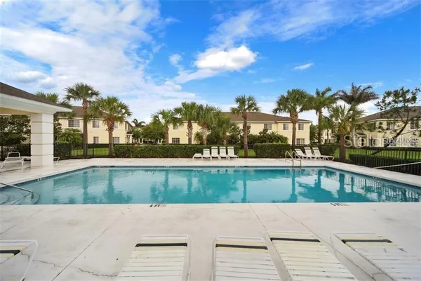 a view of swimming pool with outdoor seating and plants