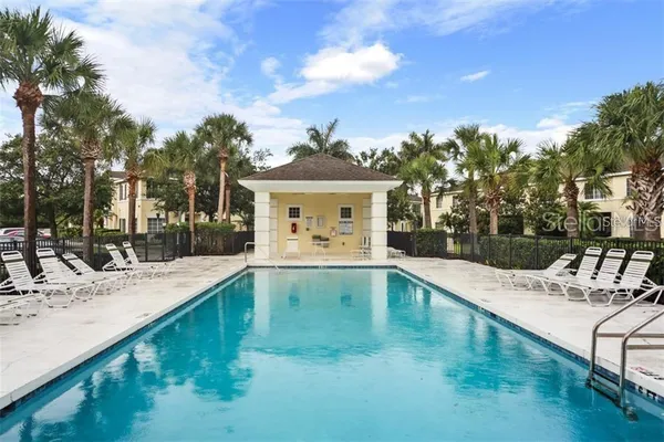 a view of a house with pool and sitting area