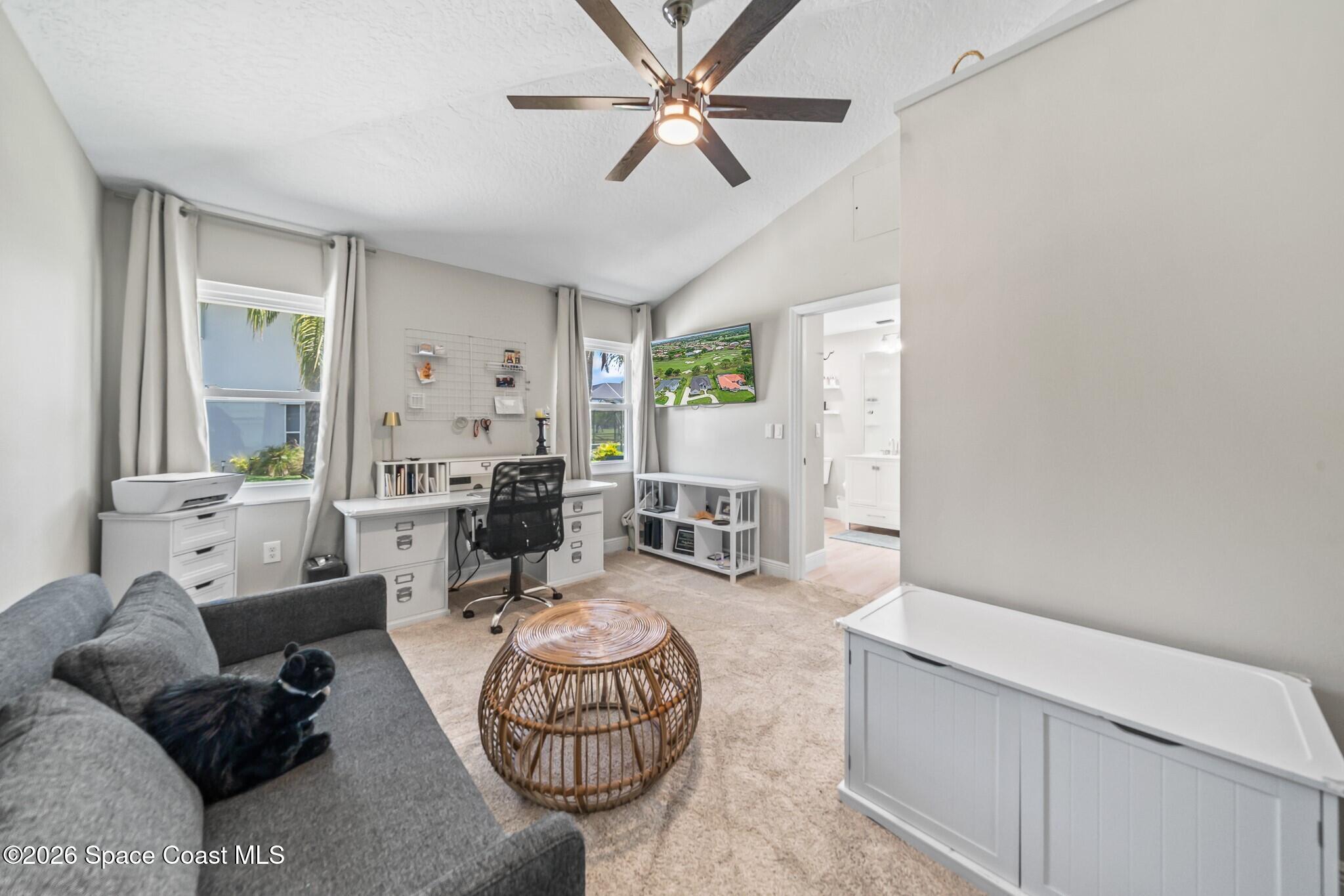697 Spring Lake Drive Melbourne, FL 32940 - Photo 22 of 45 a living room with furniture a rug and a chandelier