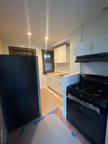 a kitchen with granite countertop a stove and a refrigerator