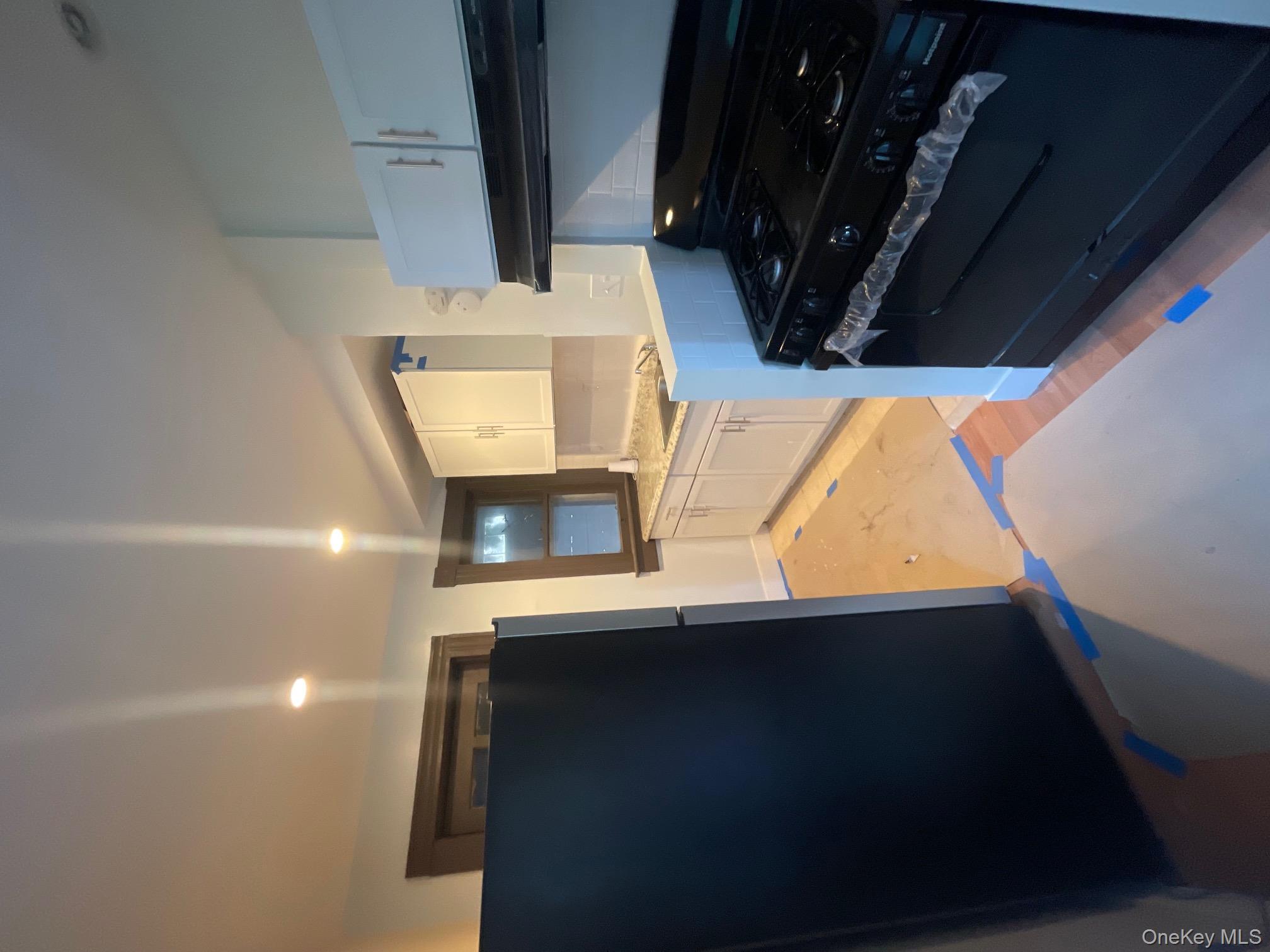 27 Poplar Street, Unit 1 Waterbury, CT 06708 - Photo 6 of 6 a kitchen with granite countertop a stove and a refrigerator