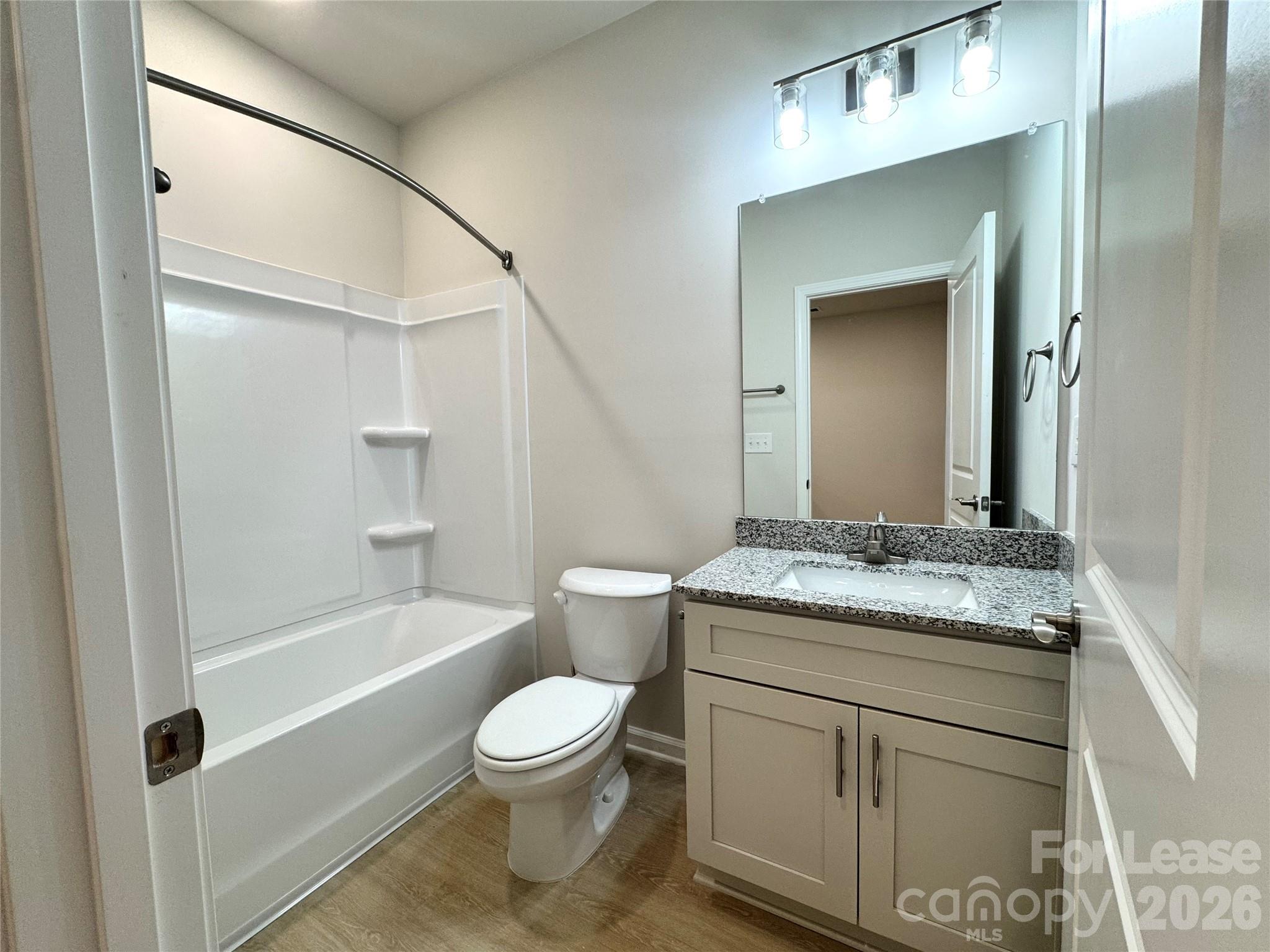 4700 Prosperity Church Road, Unit 6409 Charlotte, NC 28269 - Photo 13 of 23 a bathroom with a granite countertop sink toilet and shower