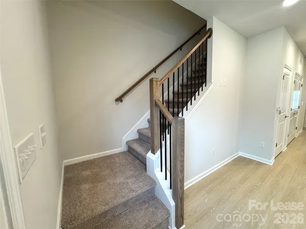 a view of a hallway with wooden floor and entryway