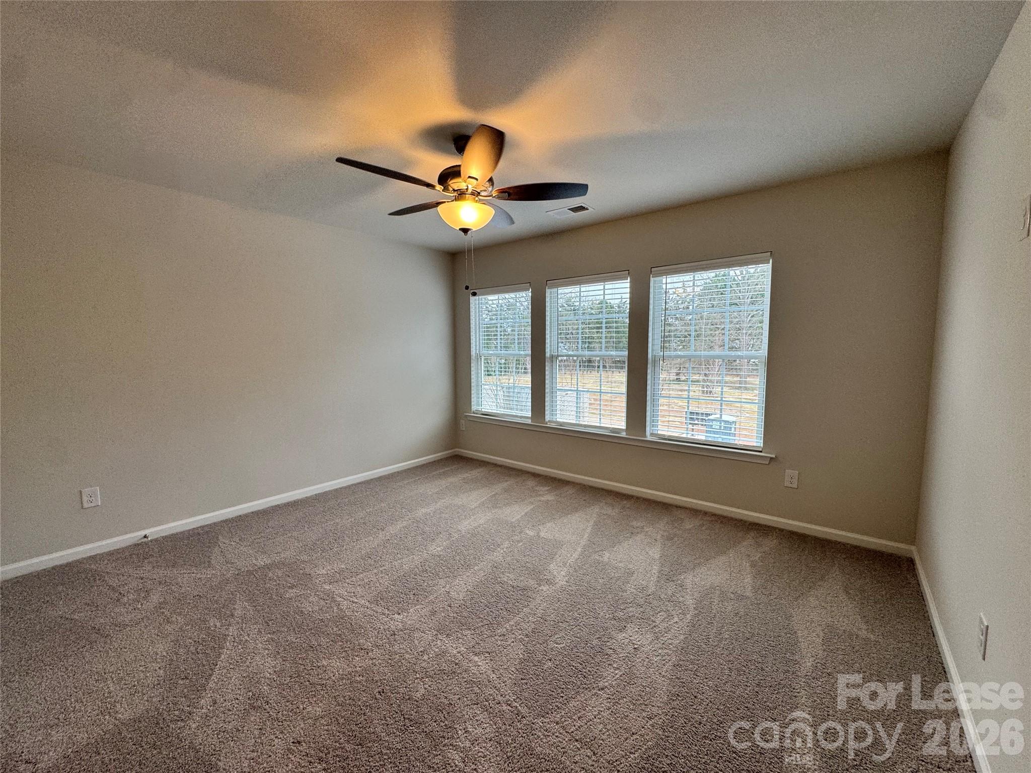 4700 Prosperity Church Road, Unit 6409 Charlotte, NC 28269 - Photo 17 of 23 an empty room with a window and a ceiling fan