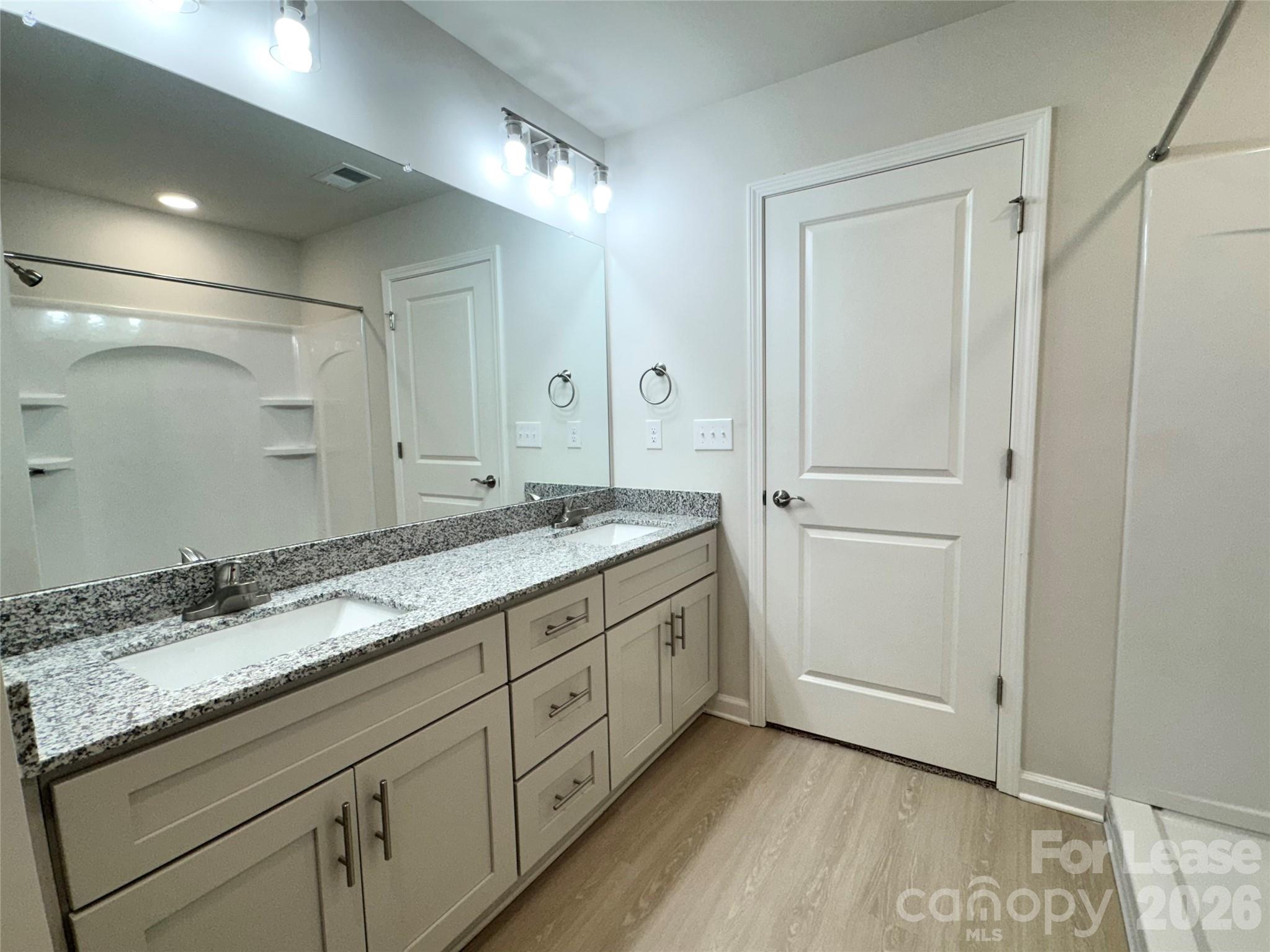 4700 Prosperity Church Road, Unit 6409 Charlotte, NC 28269 - Photo 22 of 23 a bathroom with a granite countertop sink and a mirror