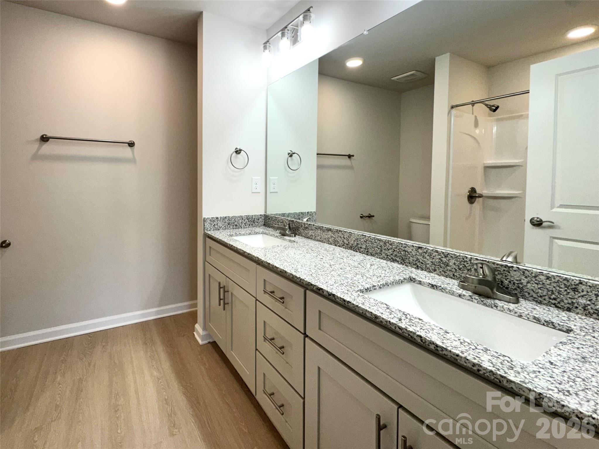 4700 Prosperity Church Road, Unit 6409 Charlotte, NC 28269 - Photo 23 of 23 a bathroom with a granite countertop sink and a mirror