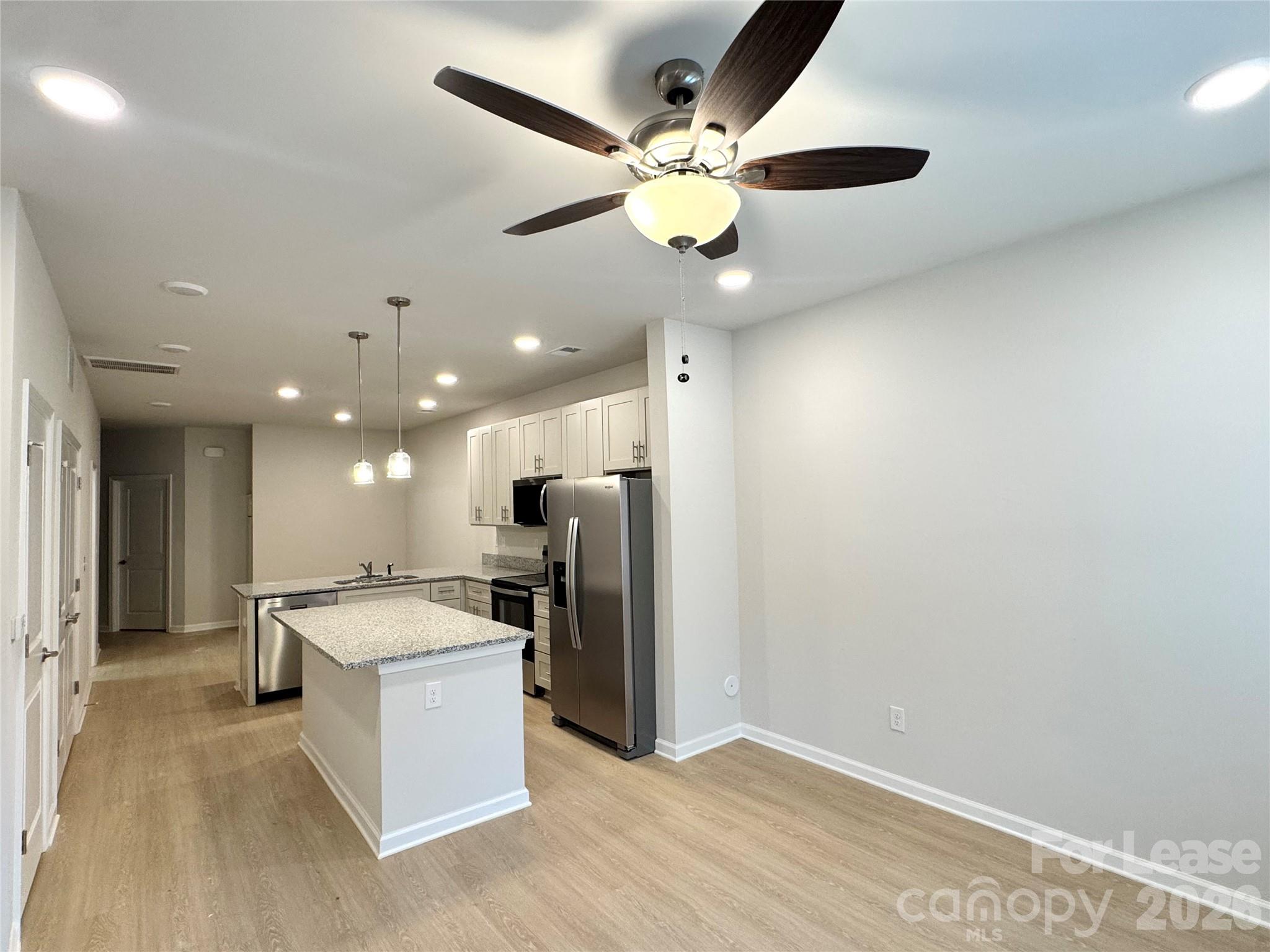 4700 Prosperity Church Road, Unit 6409 Charlotte, NC 28269 - Photo 4 of 23 a open kitchen with a refrigerator a sink dishwasher and a stove