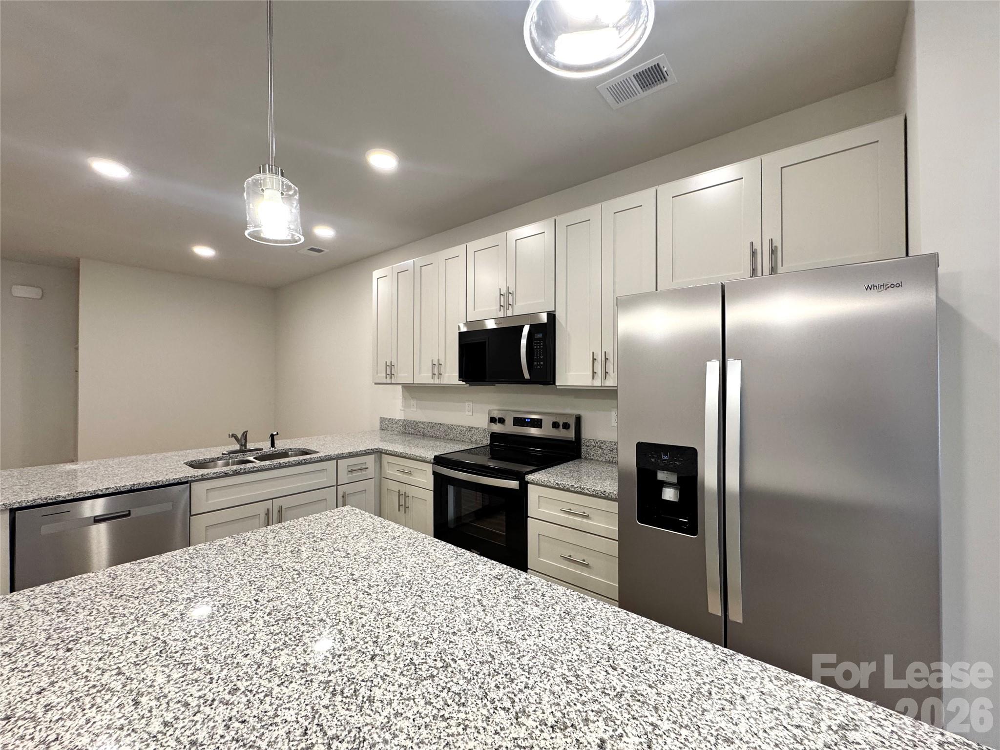 4700 Prosperity Church Road, Unit 6409 Charlotte, NC 28269 - Photo 5 of 23 a kitchen with granite countertop a refrigerator stove and sink