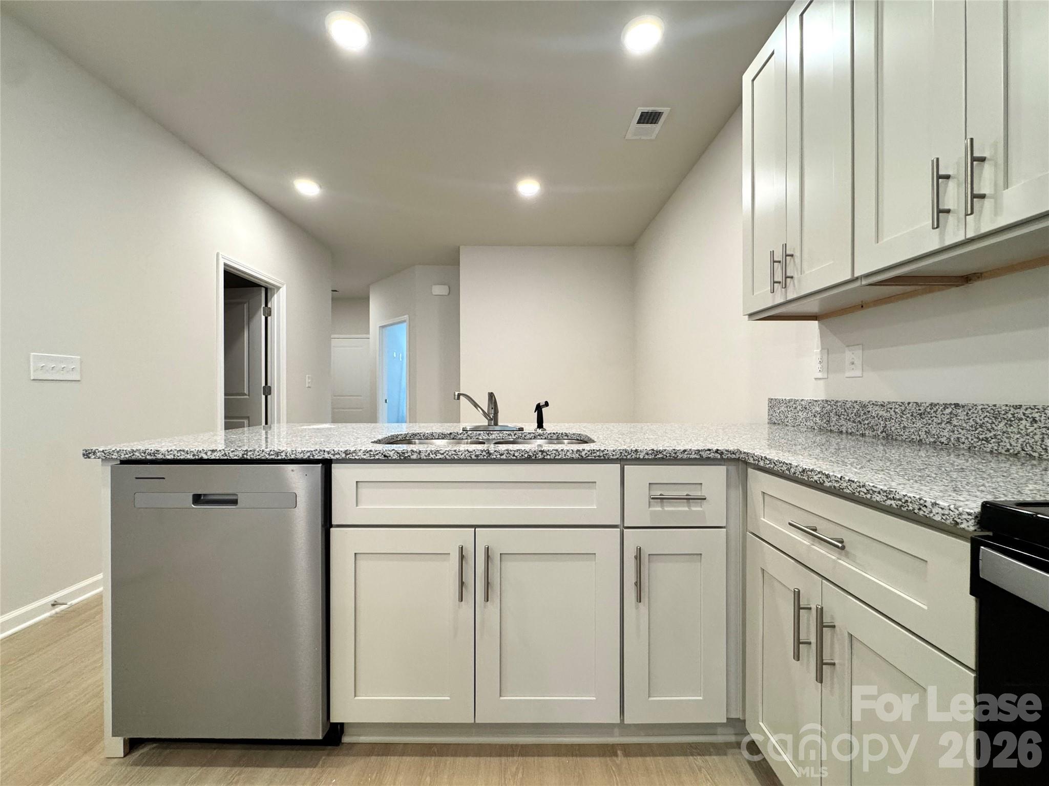 4700 Prosperity Church Road, Unit 6409 Charlotte, NC 28269 - Photo 8 of 23 a kitchen with granite countertop white cabinets and white appliances