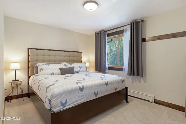 a bedroom with a bed lamp and window