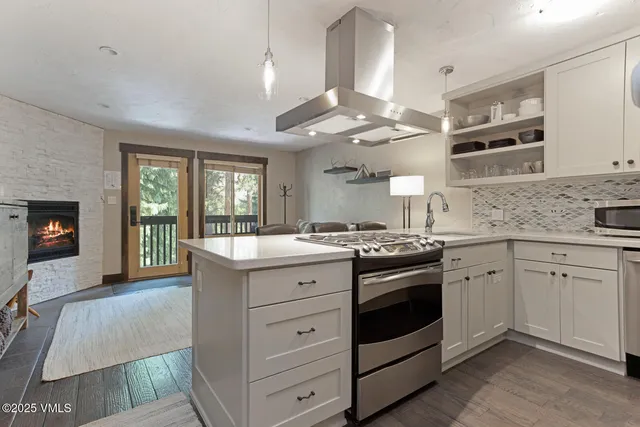 a kitchen with stainless steel appliances granite countertop a stove and cabinets