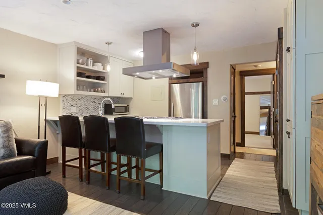 a living room with furniture a dining table and a fireplace