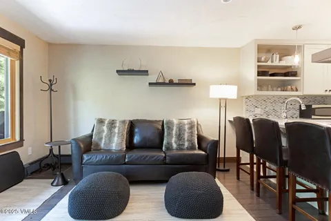 a living room with furniture and a lamp