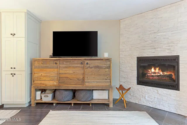 a living room with a flat screen tv and a fireplace