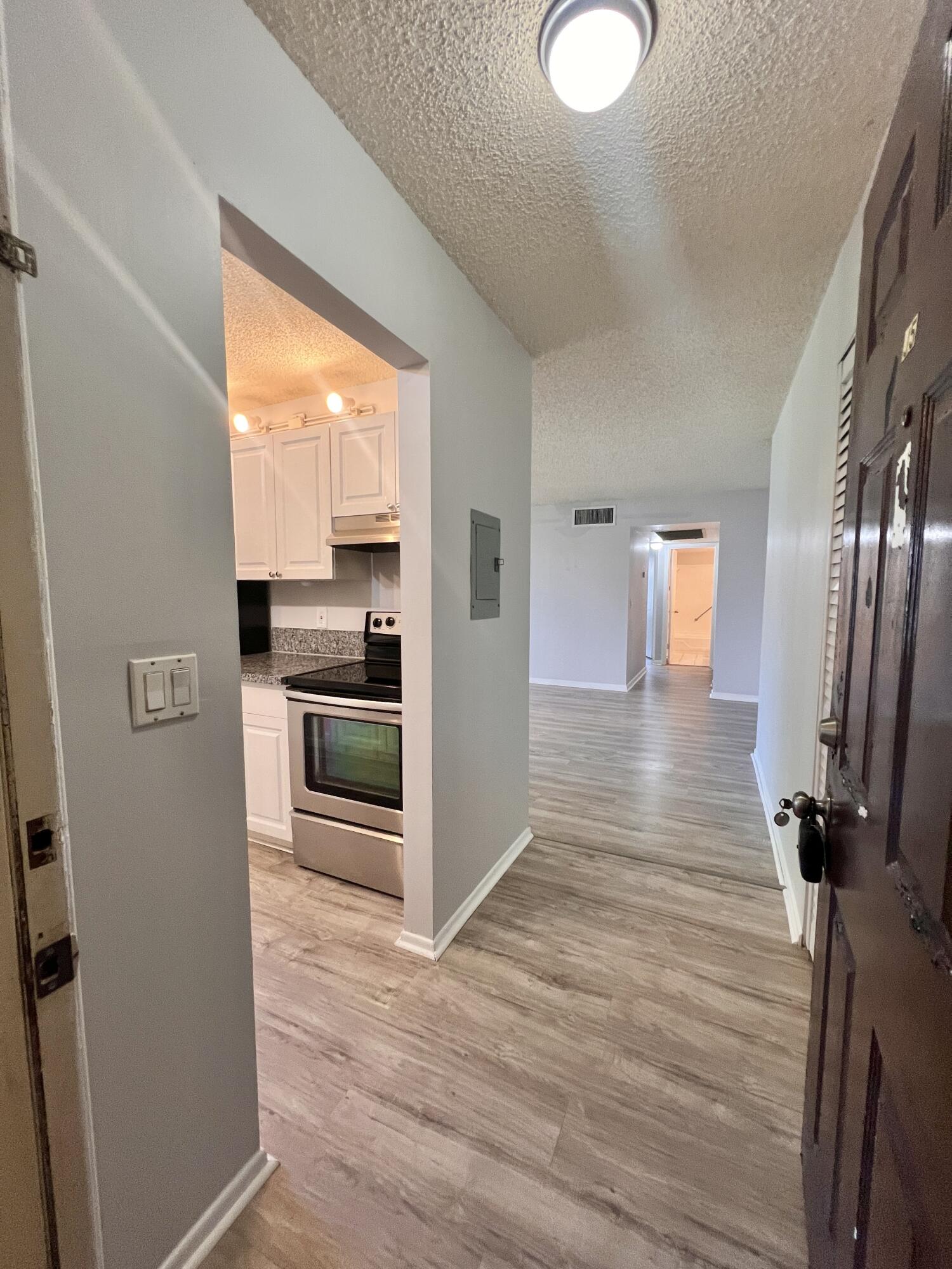 150 Pineview Road, Unit J5 Jupiter, FL 33469 - Photo 1 of 35 a view of a kitchen cabinets and wooden floor
