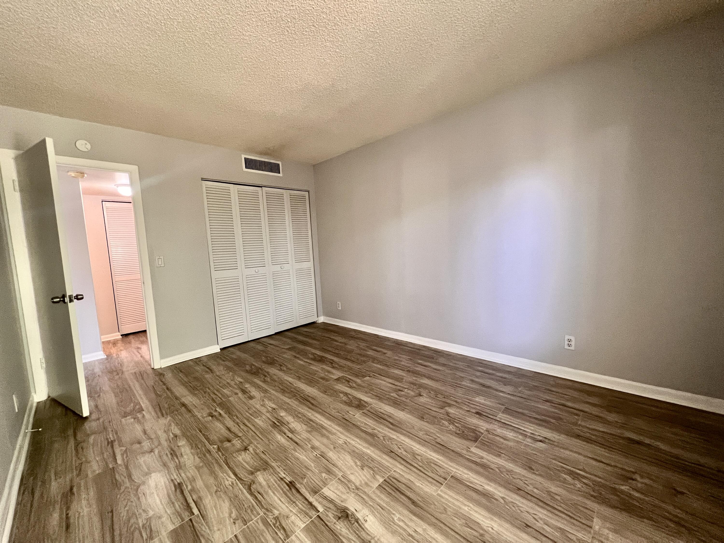 150 Pineview Road, Unit J5 Jupiter, FL 33469 - Photo 15 of 35 a view of empty room with wooden floor