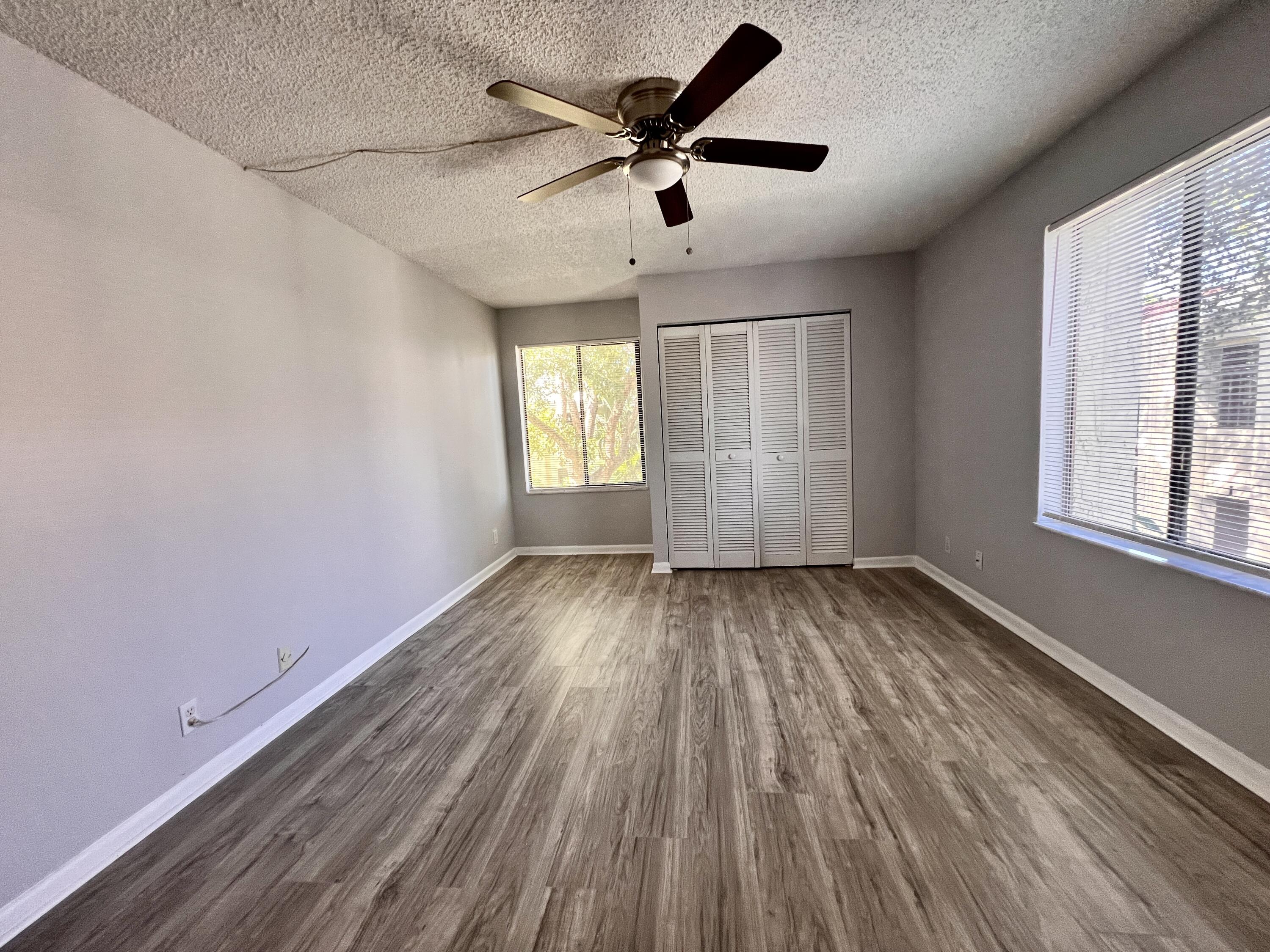 150 Pineview Road, Unit J5 Jupiter, FL 33469 - Photo 19 of 35 wooden floor in an empty room with a window