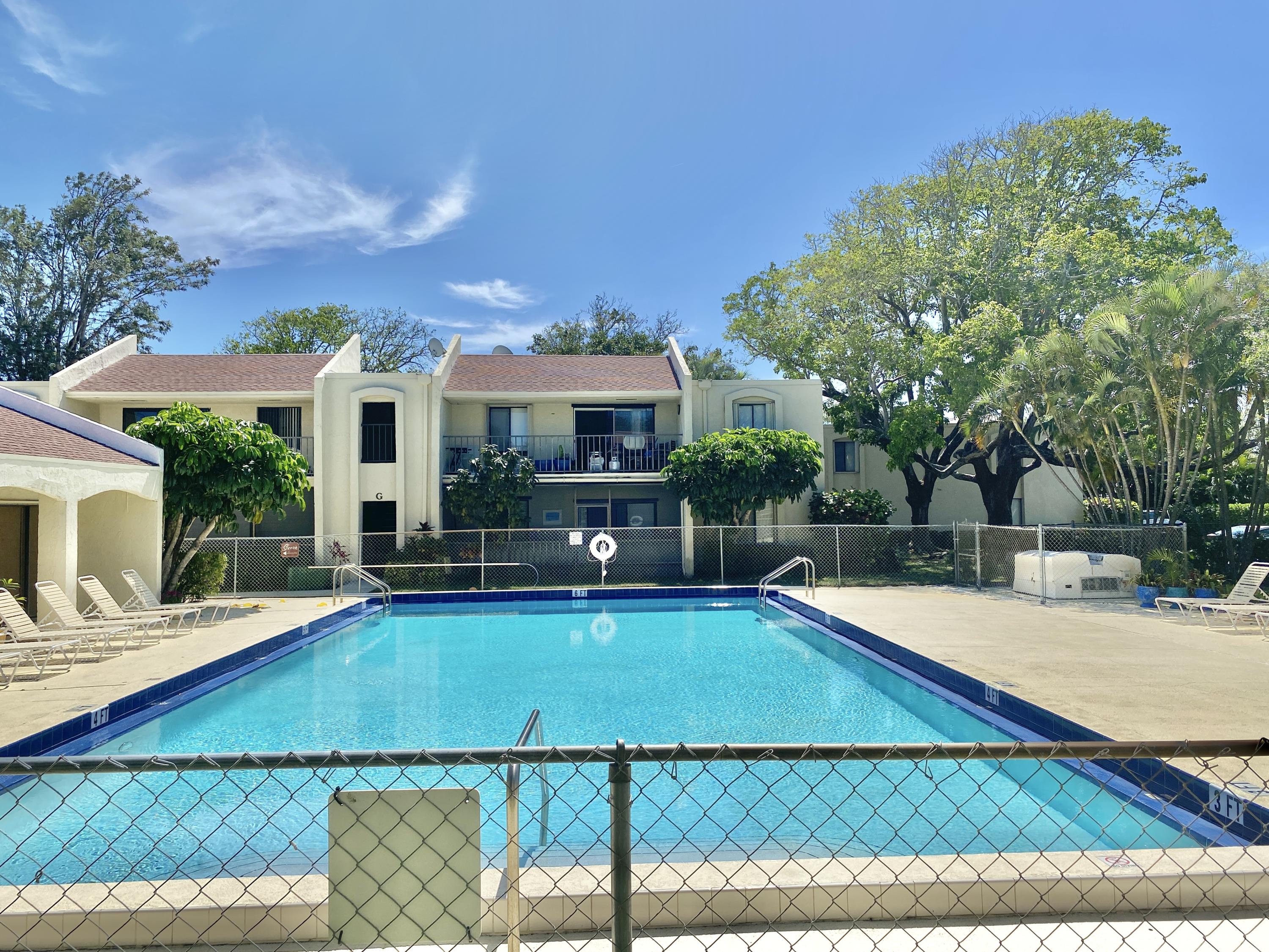 150 Pineview Road, Unit J5 Jupiter, FL 33469 - Photo 24 of 35 a view of a house with swimming pool