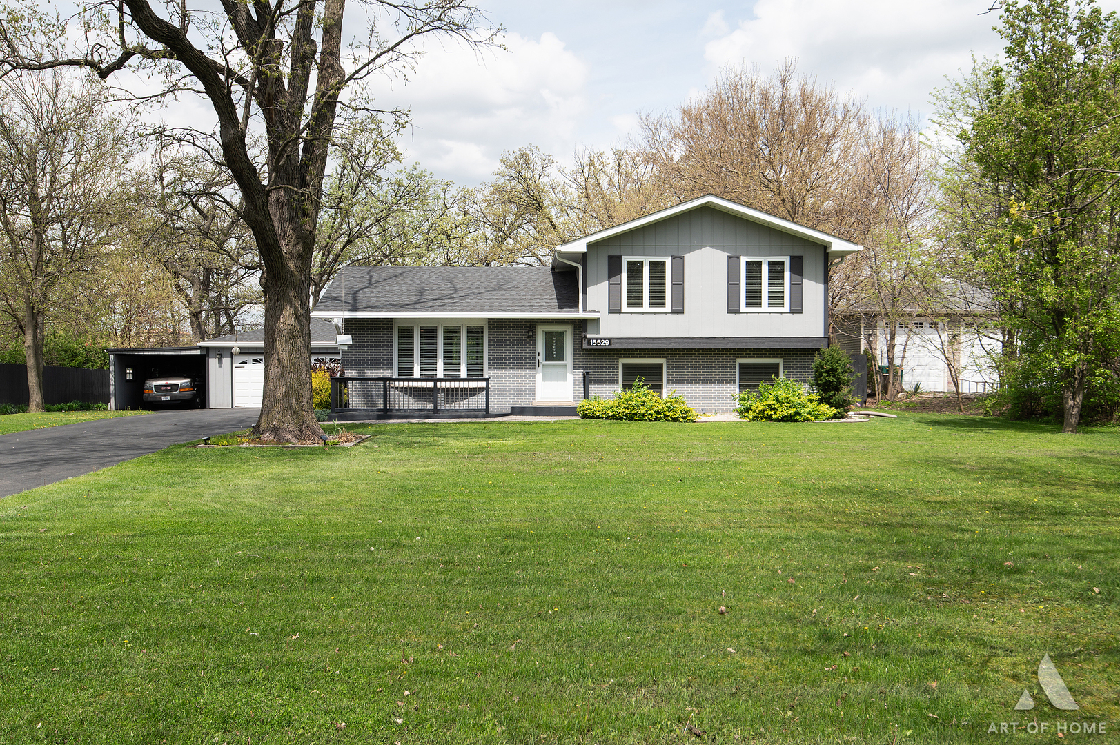 15529 129th Street Lemont, IL 60439 - Photo 5 of 65 a front view of a house with a garden and trees