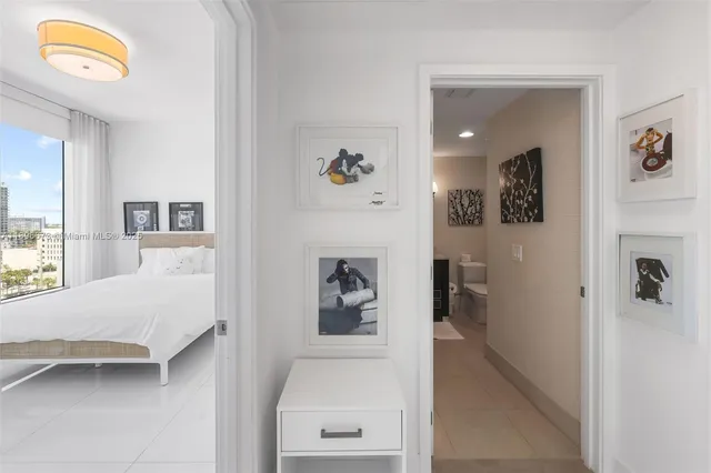 a bedroom with a bed and a painting