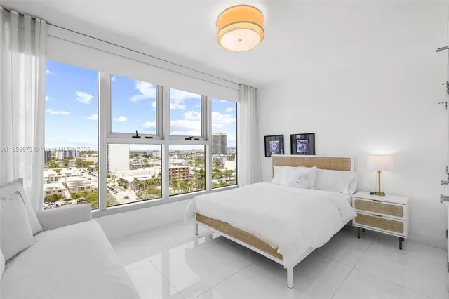 a living room with furniture and a floor to ceiling window