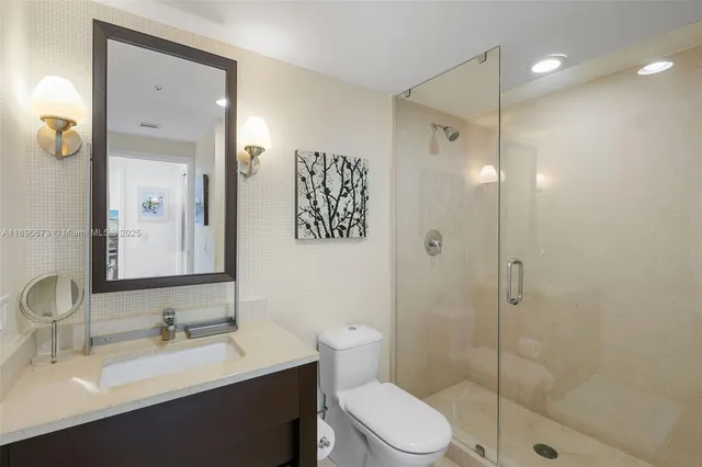 a bathroom with a shower and a glass door