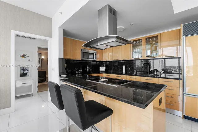 a kitchen with stainless steel appliances granite countertop a sink a stove and a refrigerator