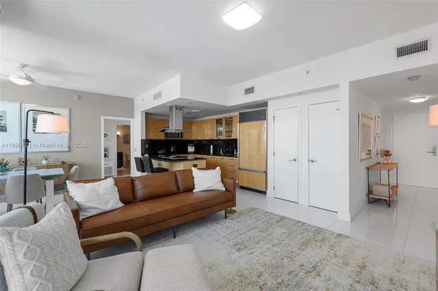 a view of living room kitchen with furniture and wooden floor