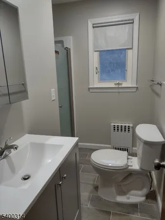 a bathroom with a sink toilet and a mirror