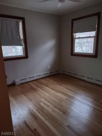 a view of a room with wooden floor and window