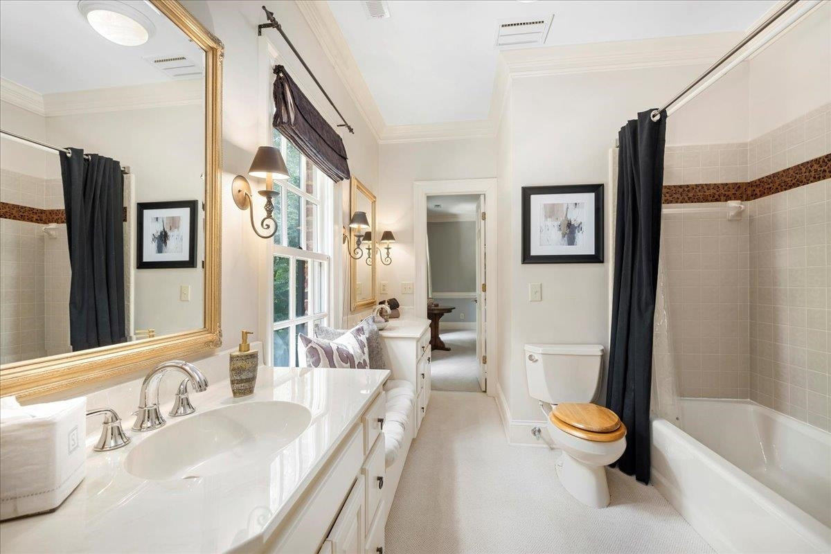 1213 Marlowe Road Raleigh, NC 27609 - Photo 25 of 30 Jack n Jill bath with adorable window seat and linen closet. Bathroom