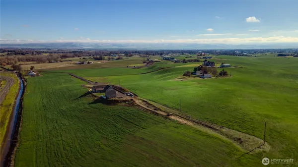 an aerial view of a golf course with a lake view