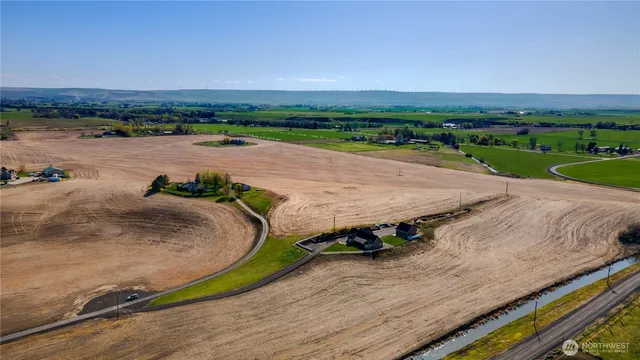 an aerial view of a house with a yard and lake view