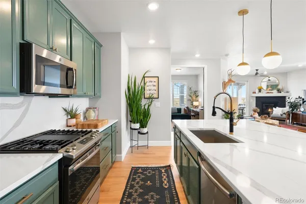 a kitchen with a sink stove and microwave