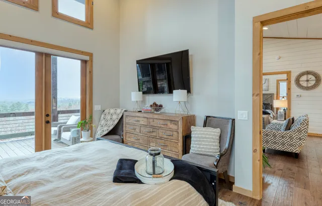 a bedroom with a bed and flat tv screen