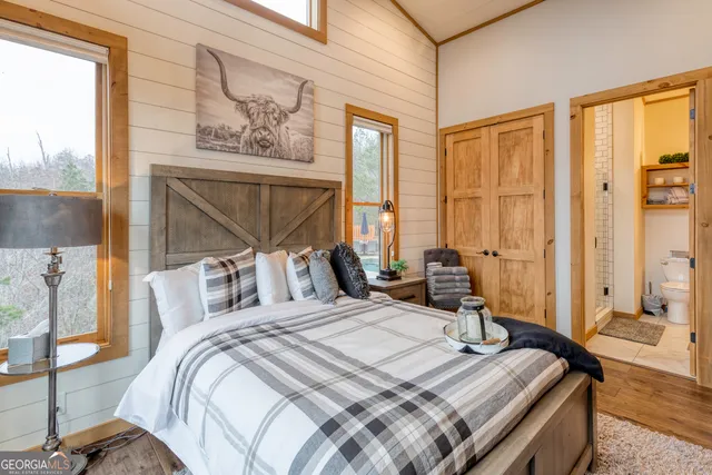 a living room with fireplace furniture and a floor to ceiling window