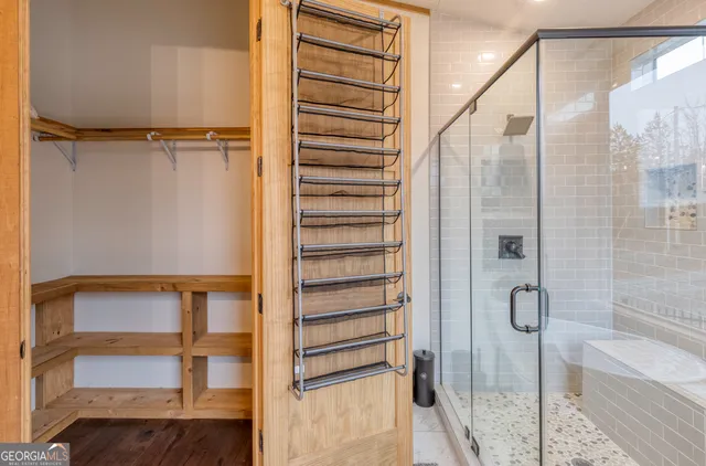 a bedroom with a large bed and a flat tv screen