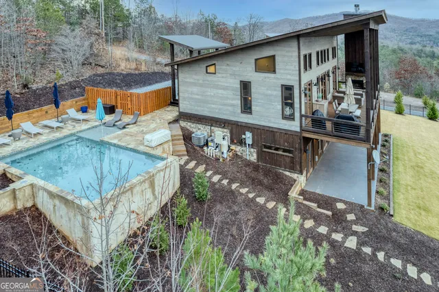 a living room with furniture a fireplace and a chandelier