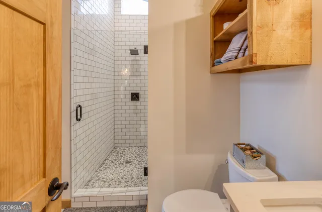 a living room with furniture pool table and a wooden floor
