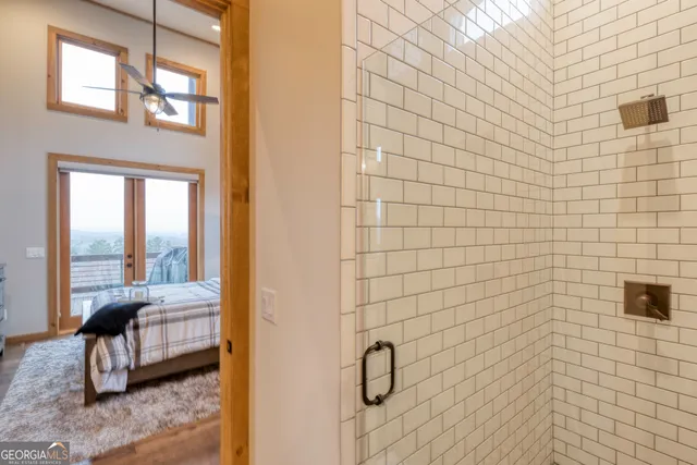 a bed sitting in a bedroom next to a window