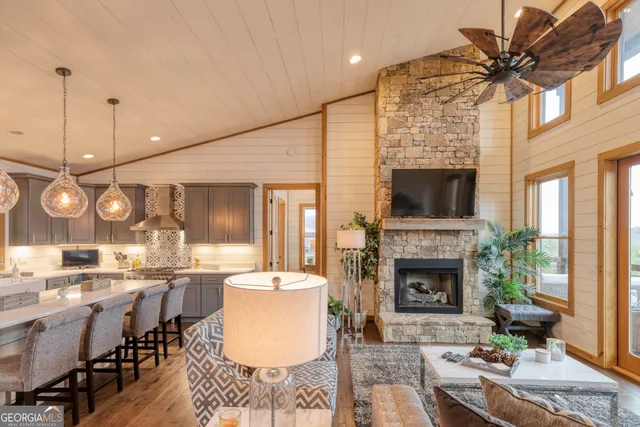 a bedroom with a bed and a large window with outer view