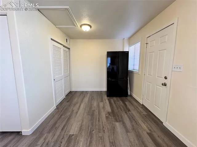 a view of empty room with wooden floor