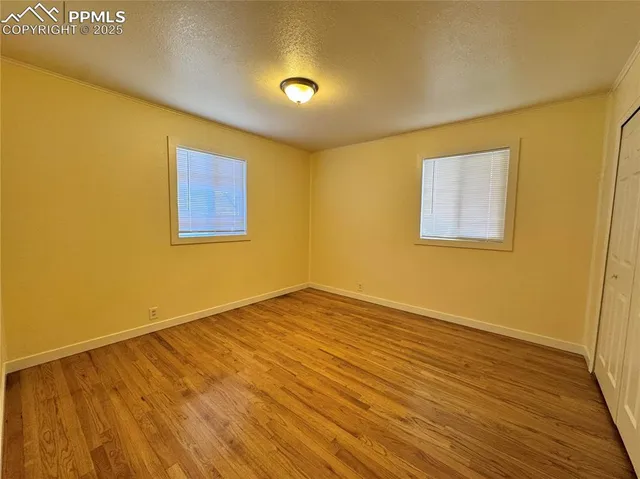 a view of a room with wooden floor and windows