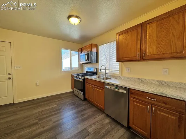 a view of hallway with wooden floor