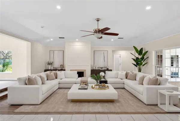 a bedroom with a large bed couch and a window